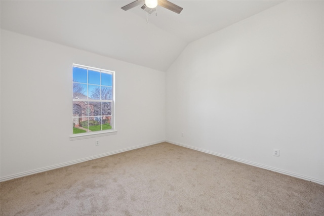 carpeted spare room with vaulted ceiling and ceiling fan