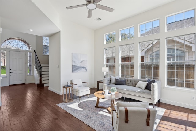 living room with dark hardwood / wood-style flooring and ceiling fan