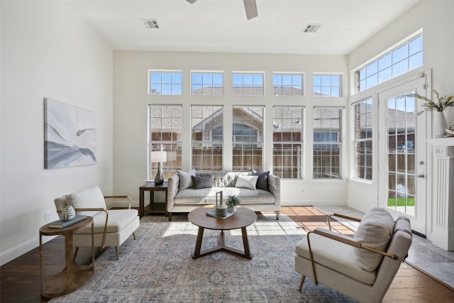 sunroom / solarium featuring a wealth of natural light and ceiling fan