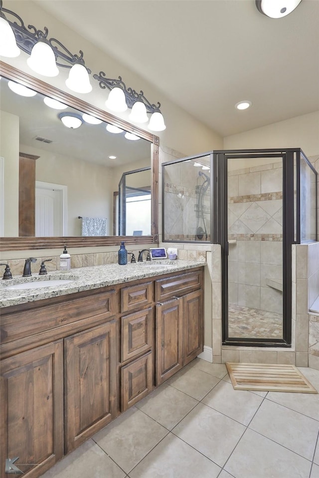 bathroom with tile patterned floors, an enclosed shower, and vanity