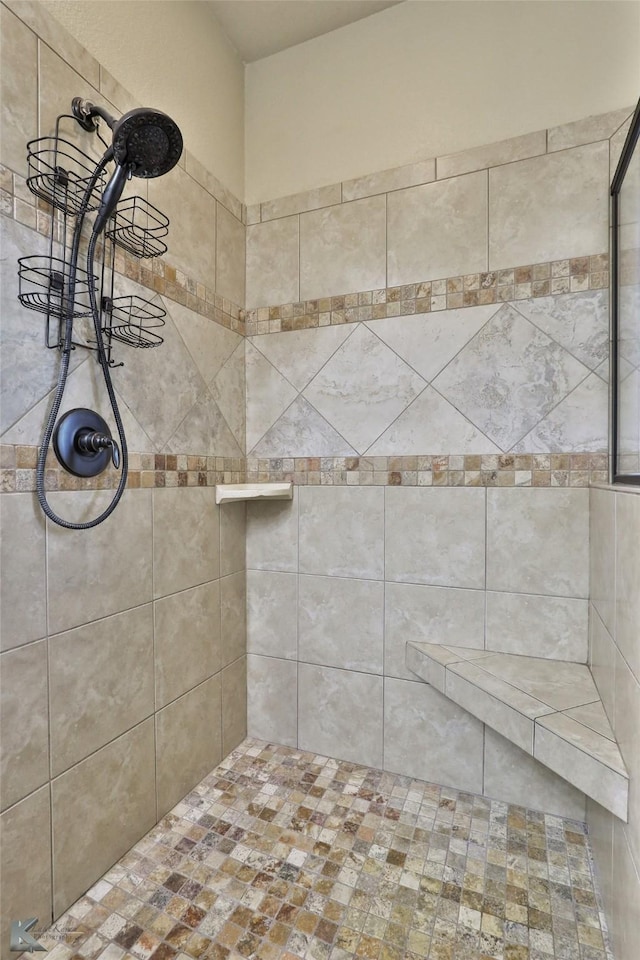 bathroom with tiled shower