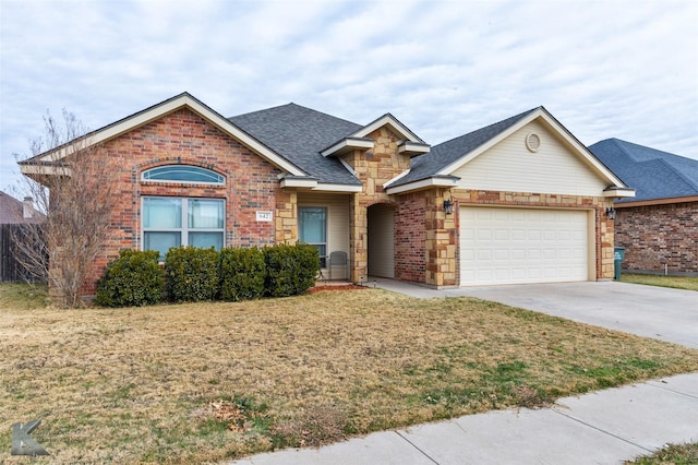 view of front of home featuring a front yard and a garage