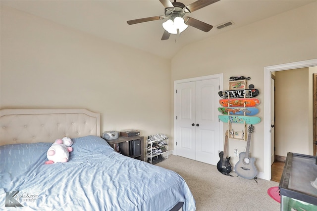 bedroom with ceiling fan, dark carpet, a closet, and vaulted ceiling