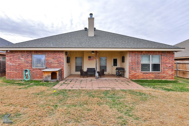 rear view of property with a lawn and a patio area