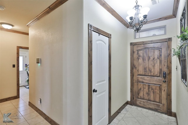 tiled entryway featuring crown molding and a chandelier