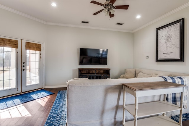 living room featuring ceiling fan, wood-type flooring, crown molding, and french doors