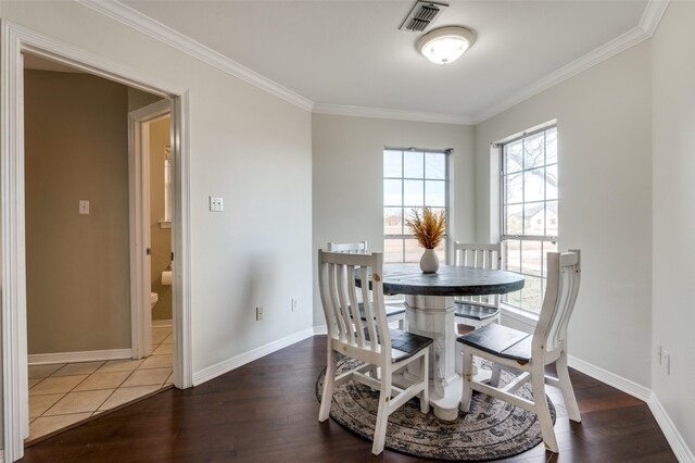 kitchen with light tile patterned floors, stainless steel fridge, ceiling fan, dark stone counters, and crown molding