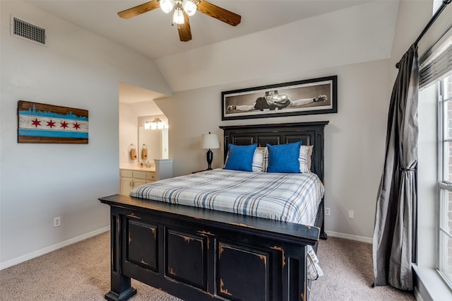 carpeted bedroom featuring ceiling fan, ensuite bathroom, and lofted ceiling