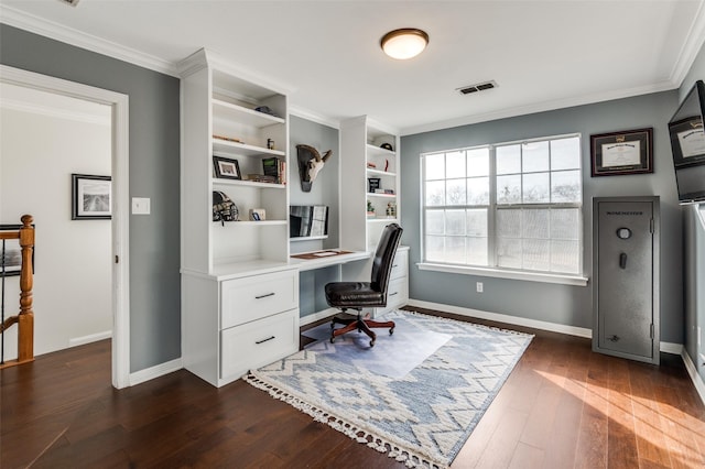 home office with dark hardwood / wood-style flooring, crown molding, and built in desk