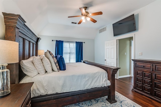 bedroom featuring ceiling fan, dark hardwood / wood-style flooring, and lofted ceiling