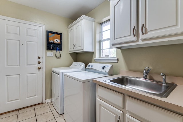 laundry area with cabinets, light tile patterned floors, independent washer and dryer, and sink