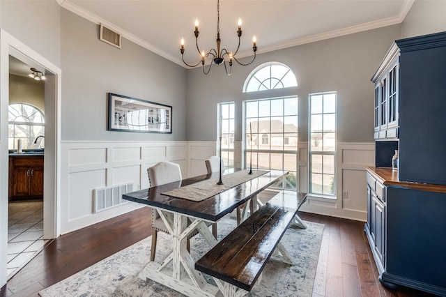 dining space with dark wood-style floors, plenty of natural light, and visible vents