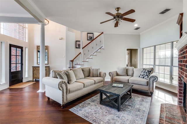 living room with ceiling fan, ornamental molding, dark hardwood / wood-style flooring, and decorative columns