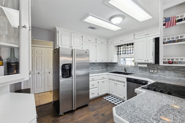 kitchen featuring white cabinets, sink, dark hardwood / wood-style flooring, backsplash, and stainless steel appliances