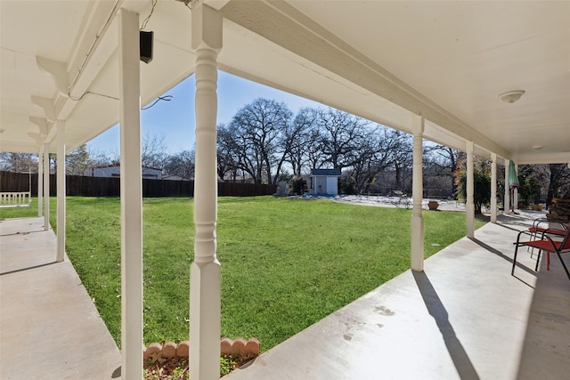 view of yard featuring a patio and a storage shed