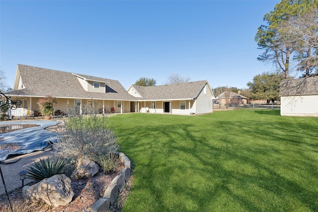 back of house with a lawn