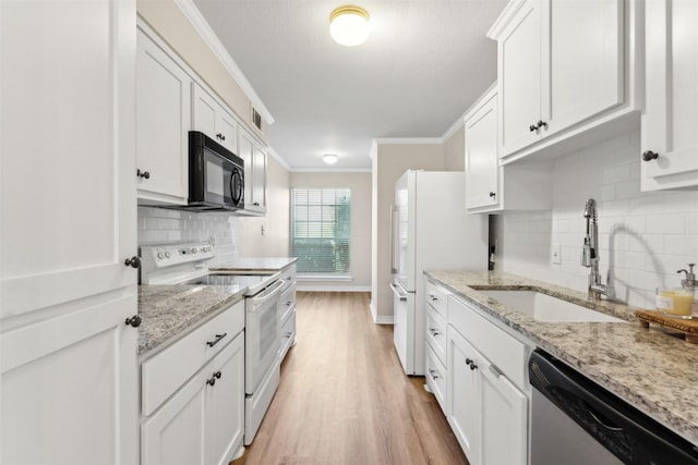 kitchen featuring sink, white cabinets, light stone counters, and white appliances