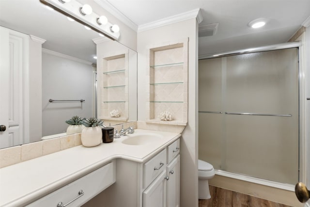 bathroom featuring toilet, a shower with door, wood-type flooring, ornamental molding, and vanity