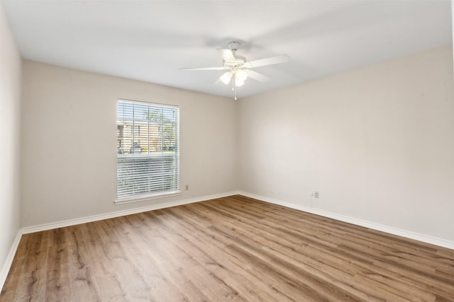 empty room with ceiling fan and light wood-type flooring