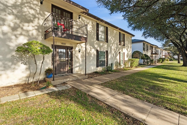 exterior space featuring a front yard and a balcony