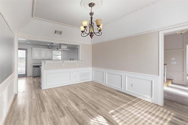 interior space featuring light hardwood / wood-style flooring and a notable chandelier