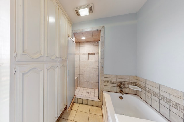 bathroom with independent shower and bath and tile patterned flooring