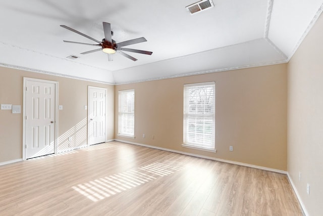 spare room with light hardwood / wood-style floors, ornamental molding, lofted ceiling, and ceiling fan