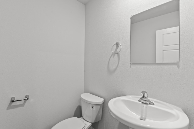 bathroom featuring sink and toilet