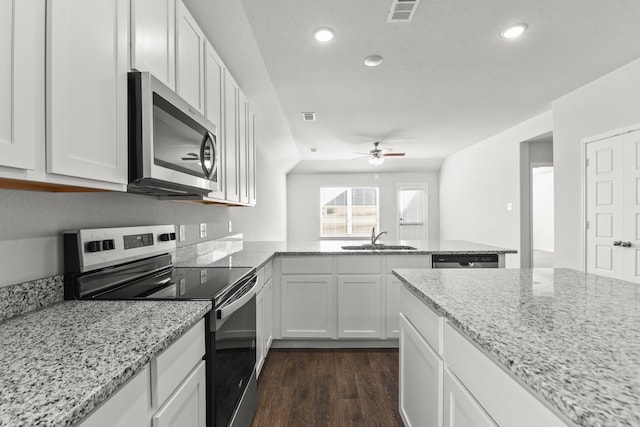 kitchen featuring light stone countertops, appliances with stainless steel finishes, sink, and white cabinetry