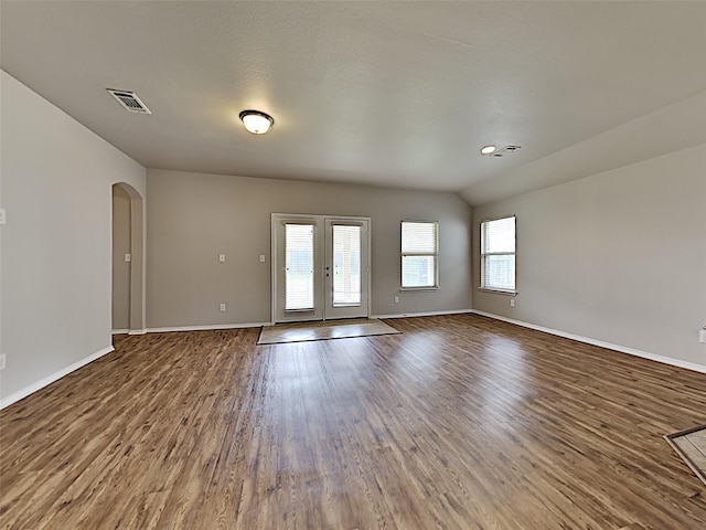 spare room with french doors, lofted ceiling, and hardwood / wood-style flooring