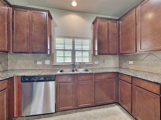 kitchen featuring stainless steel dishwasher, backsplash, sink, and light stone counters