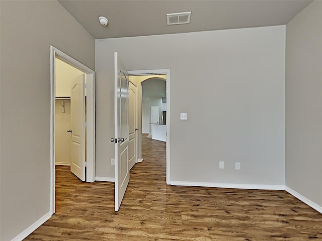 unfurnished room with dark hardwood / wood-style flooring