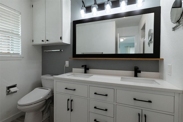 bathroom featuring toilet and vanity