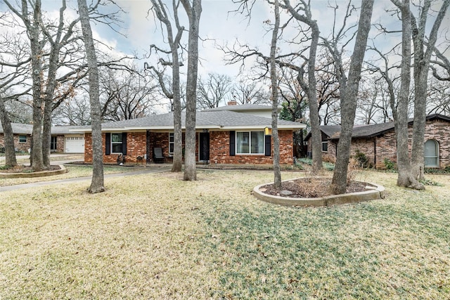 ranch-style home with a front lawn and a garage