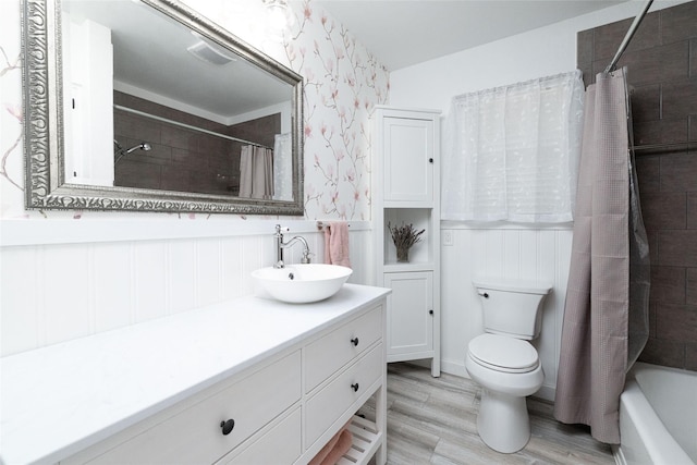 full bathroom featuring toilet, shower / tub combo, wood-type flooring, and vanity