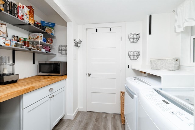 washroom featuring light hardwood / wood-style floors and independent washer and dryer