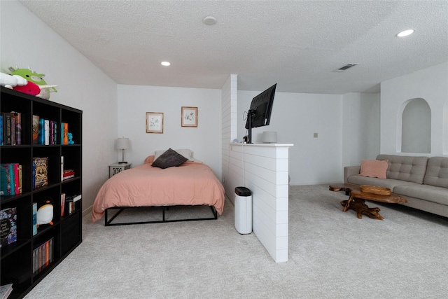 carpeted bedroom with a textured ceiling