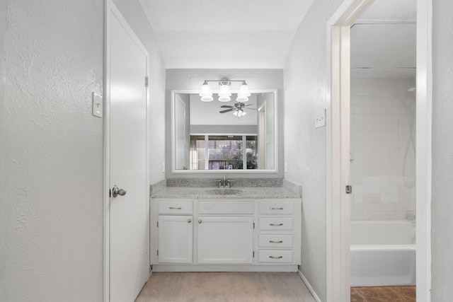 bathroom with vanity and tiled shower / bath