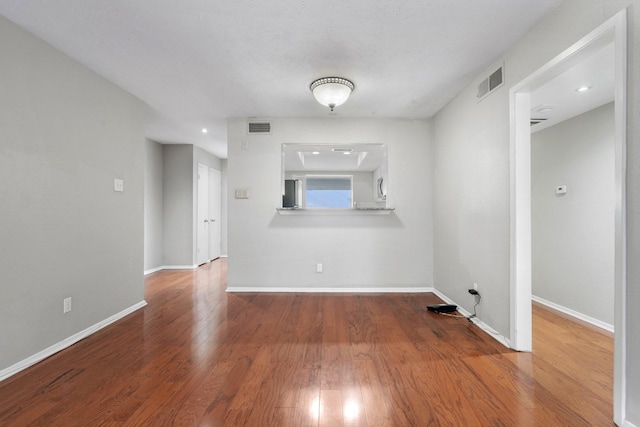 empty room with hardwood / wood-style floors