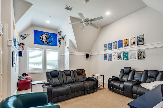 cinema with ceiling fan, lofted ceiling, and light carpet