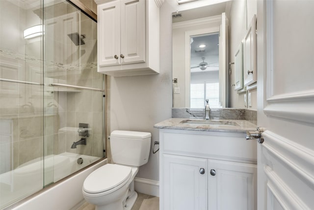 full bathroom featuring toilet, enclosed tub / shower combo, and vanity