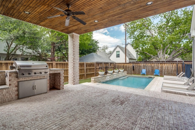 view of swimming pool with ceiling fan, a grill, exterior kitchen, and a patio