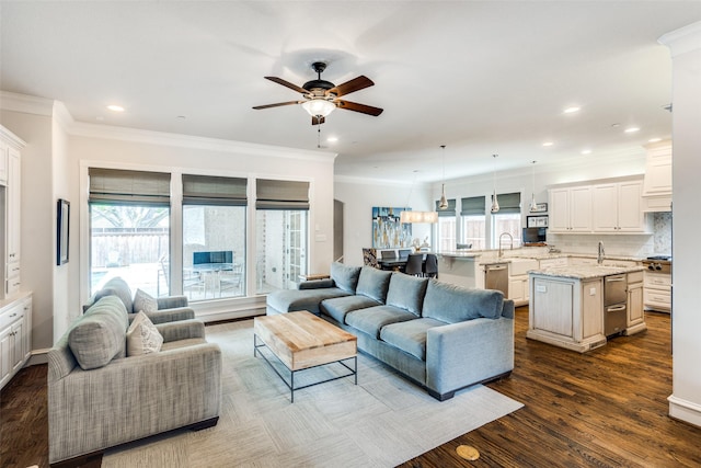 living room with ceiling fan, dark hardwood / wood-style flooring, and ornamental molding