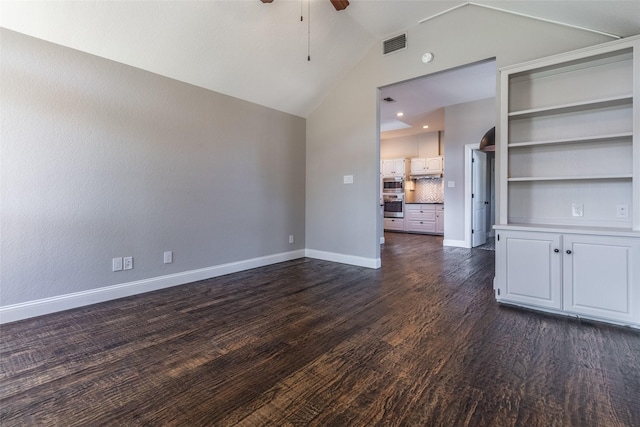 unfurnished living room featuring ceiling fan, built in shelves, dark hardwood / wood-style flooring, and vaulted ceiling