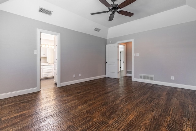 unfurnished bedroom with ceiling fan, ensuite bathroom, lofted ceiling, and dark hardwood / wood-style flooring