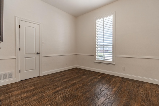 unfurnished room featuring dark wood-type flooring