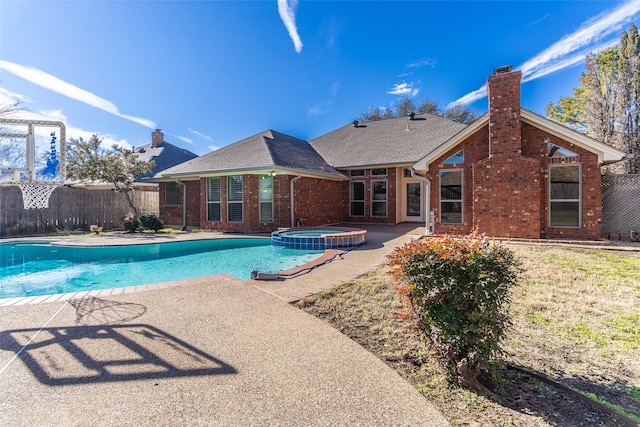 view of swimming pool featuring a patio and an in ground hot tub