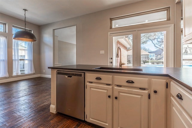 kitchen featuring white cabinetry, decorative light fixtures, dark hardwood / wood-style flooring, stainless steel dishwasher, and sink