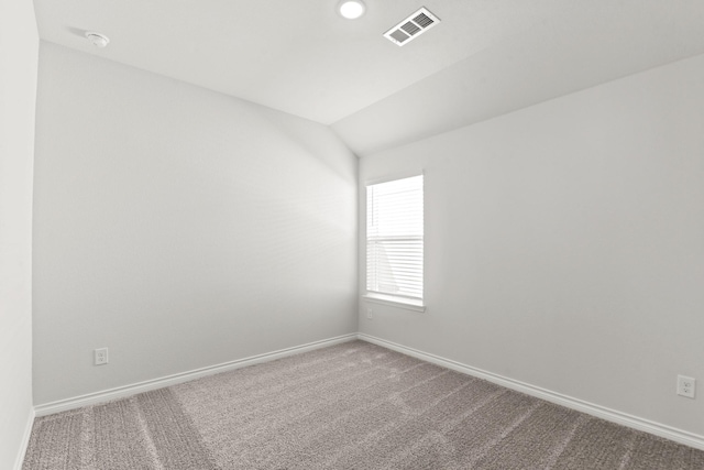 empty room with vaulted ceiling and carpet