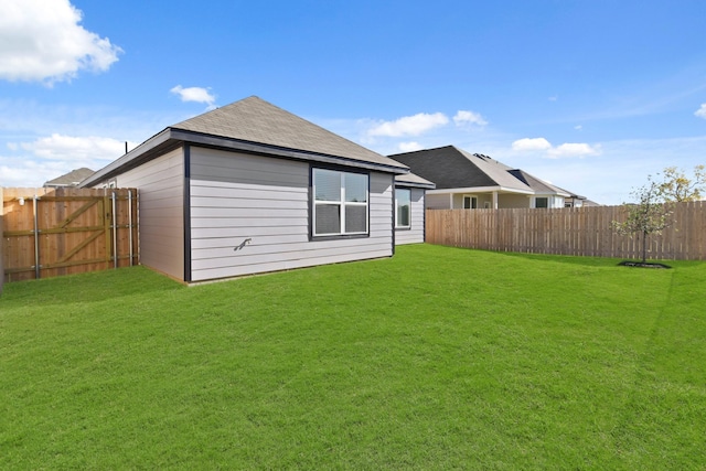 rear view of property featuring a lawn